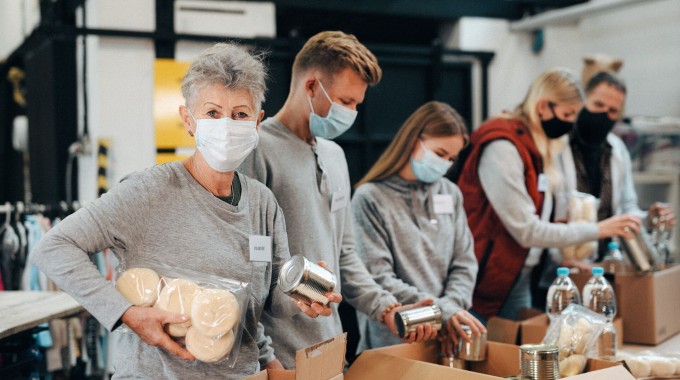 Personas rellenando cajas voluntarias